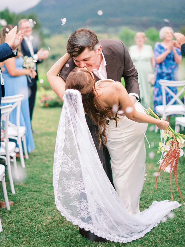 Will dipping Alex for a kiss as confetti falls and guests cheer