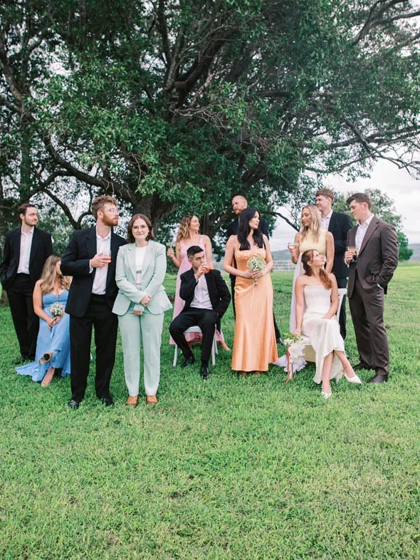 Bridal party gathered beneath a large shade tree on the lawn at Maroon Hill Estate