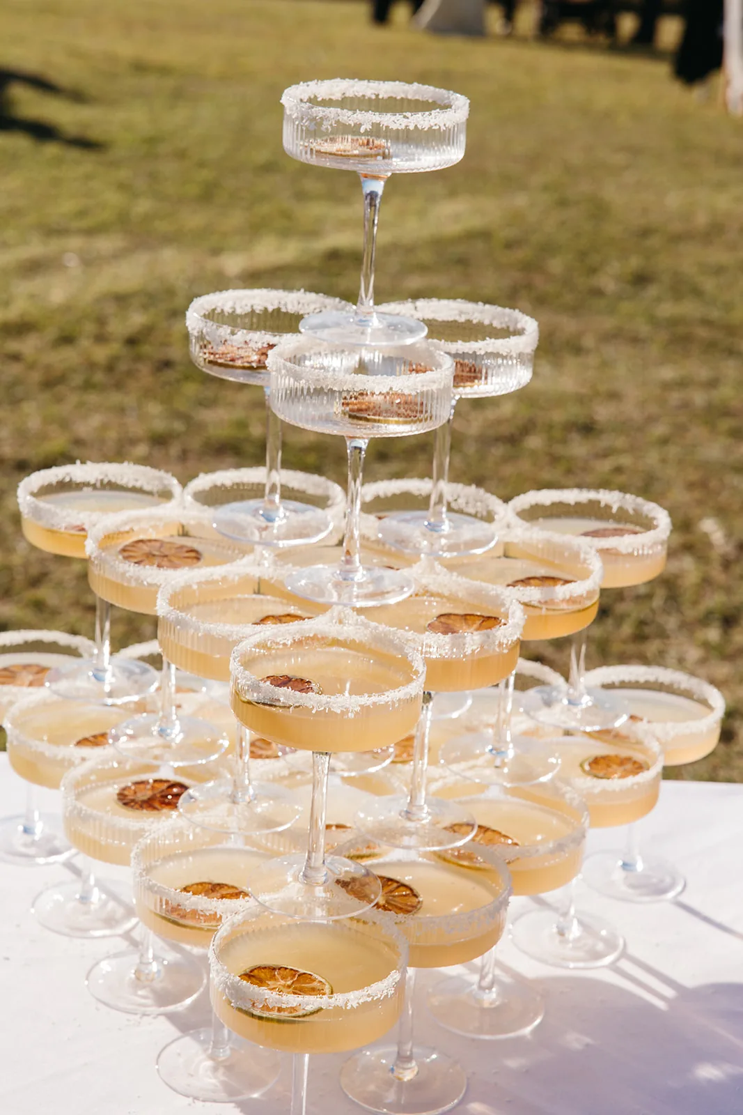 Tiered tower of margarita cocktails garnished with dried citrus