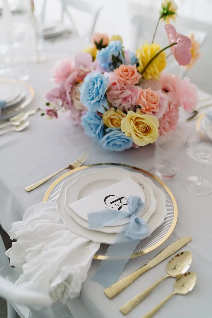 Pastel floral reception table setting at Chelsea and Rhys' wedding at Maroon Hill Estate