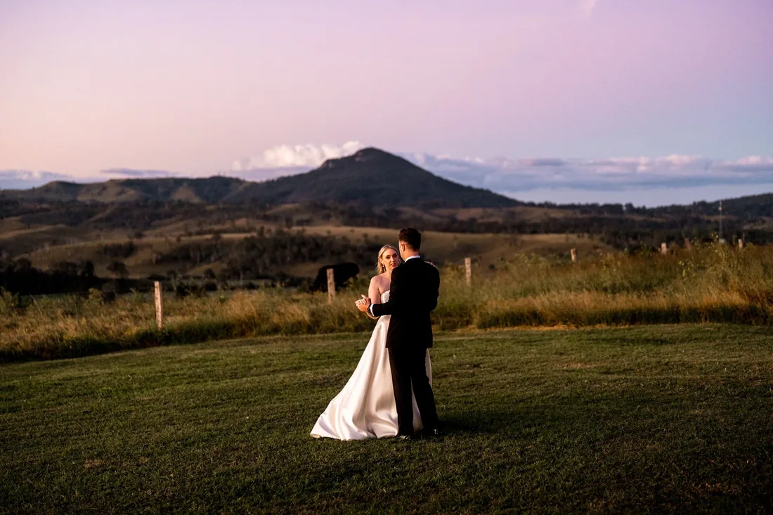 Gabi and Alec sharing a quiet dance on the lawn as the sun sets