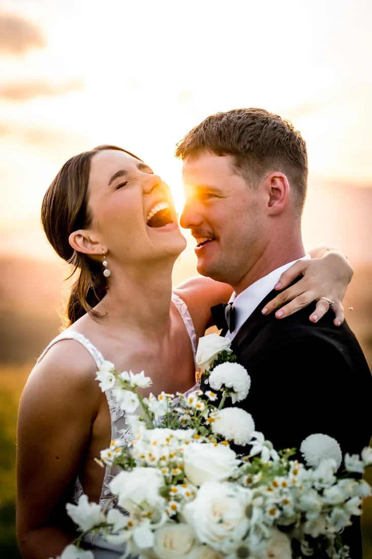 Gorgia and Nick laughing together at golden hour at Maroon Hill Estate