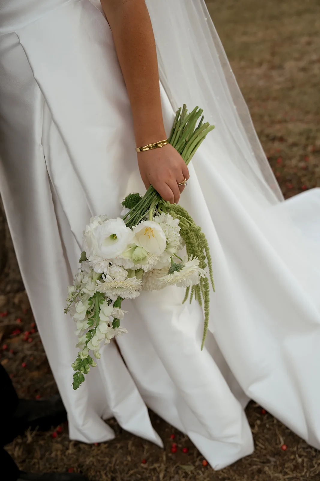 Close-up of the bridal bouquet with white flowers and trailing amaranthus