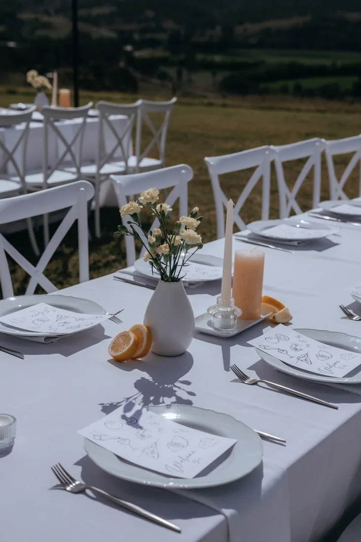 Reception table setting with citrus and florals at Maroon Hill Estate