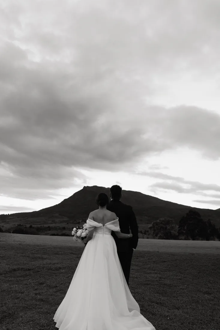 Jorjia and James viewed from behind looking out at Mount Maroon