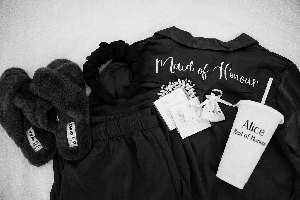 Maid of Honour black robe, slippers and personalised cup laid out flat