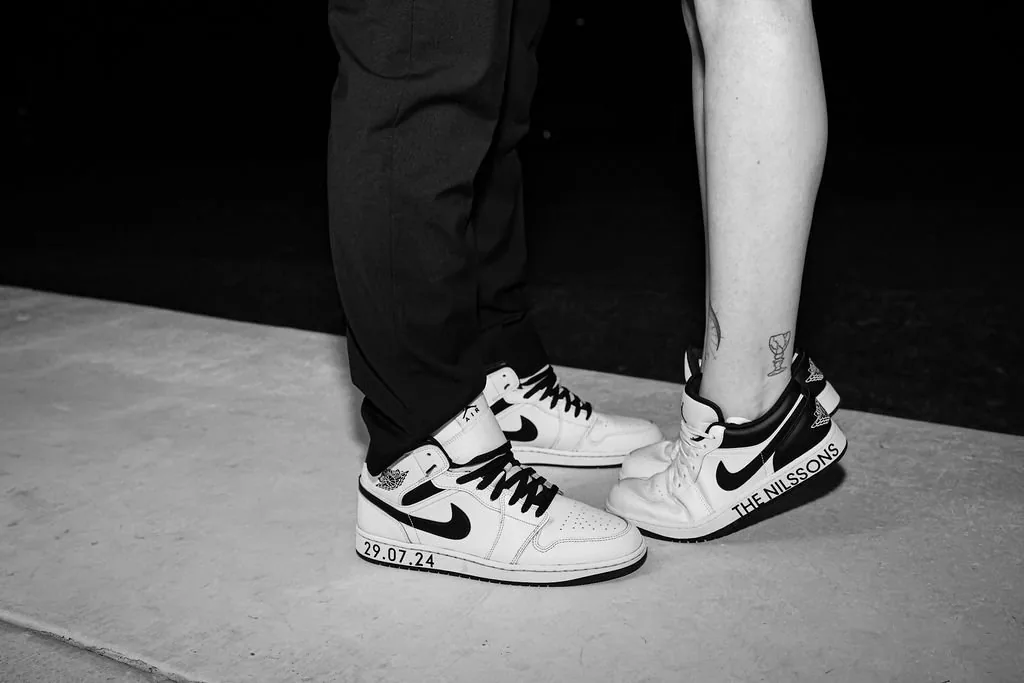 Detail shot of Kate and Jacob's matching personalised sneakers with their wedding date