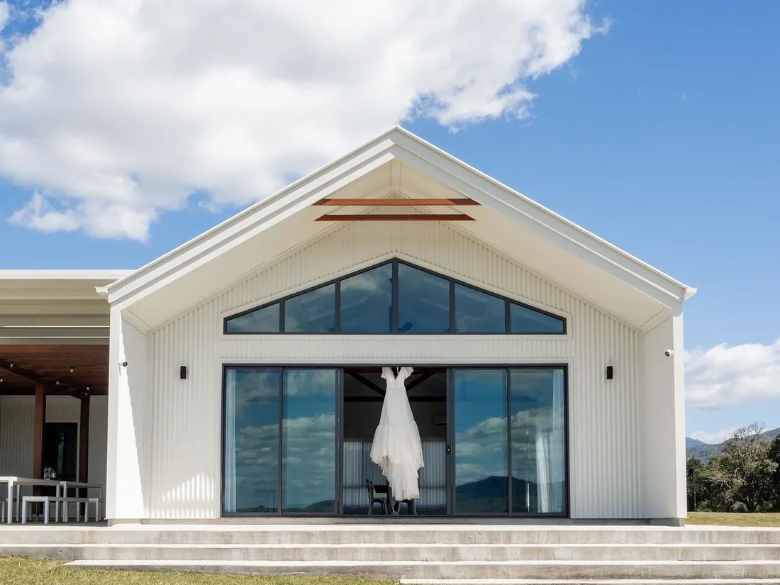 Wedding dress hanging in the gable window of the reception building