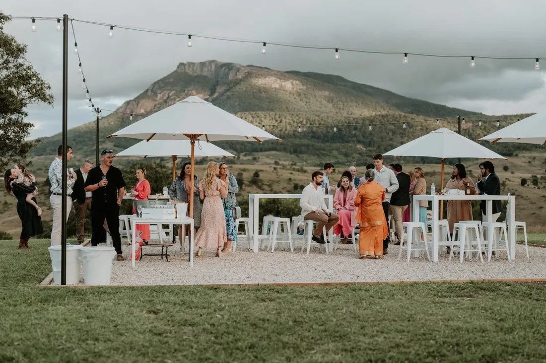 Sarah and Rhys embracing at golden hour with mountain views at Maroon Hill Estate