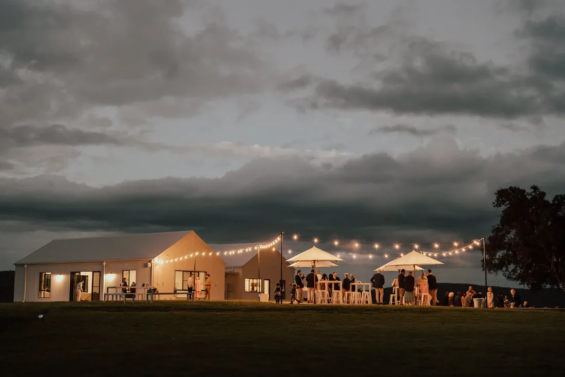 Reception dancing under festoon lights at Maroon Hill Estate at night