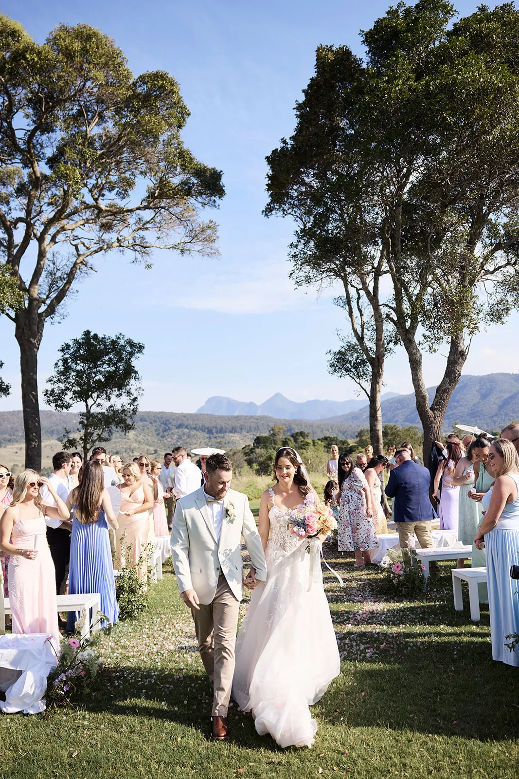 Taylor and Jayden walking back down the aisle through confetti as guests celebrate