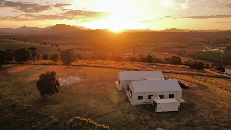 Aerial view of Maroon Hill Estate at sunset, the reception venue and ceremony lawn with Mount Maroon on the horizon